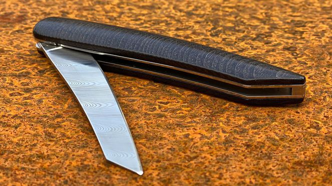 
                    Pocketknife damascus: a swiss knife performing as steak knife to go